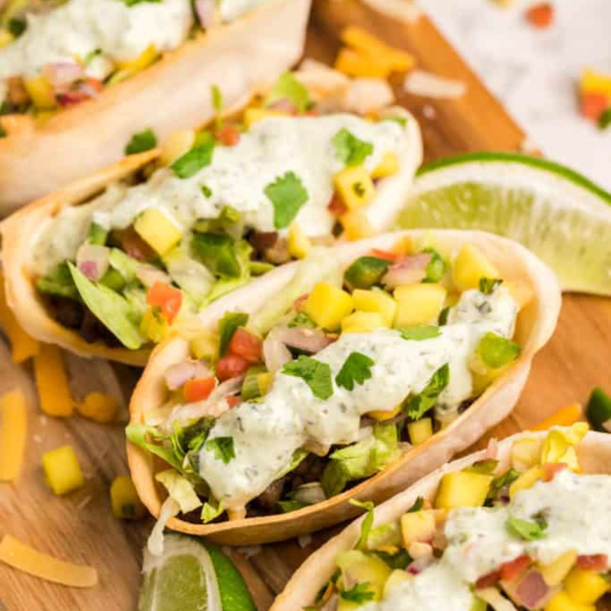 Air fryer mini taco boats filled with seasoned beef, cheese, lettuce, and pico de gallo