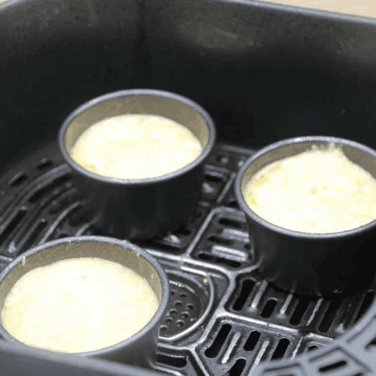 Place the muffin cups into the air fryer basket.