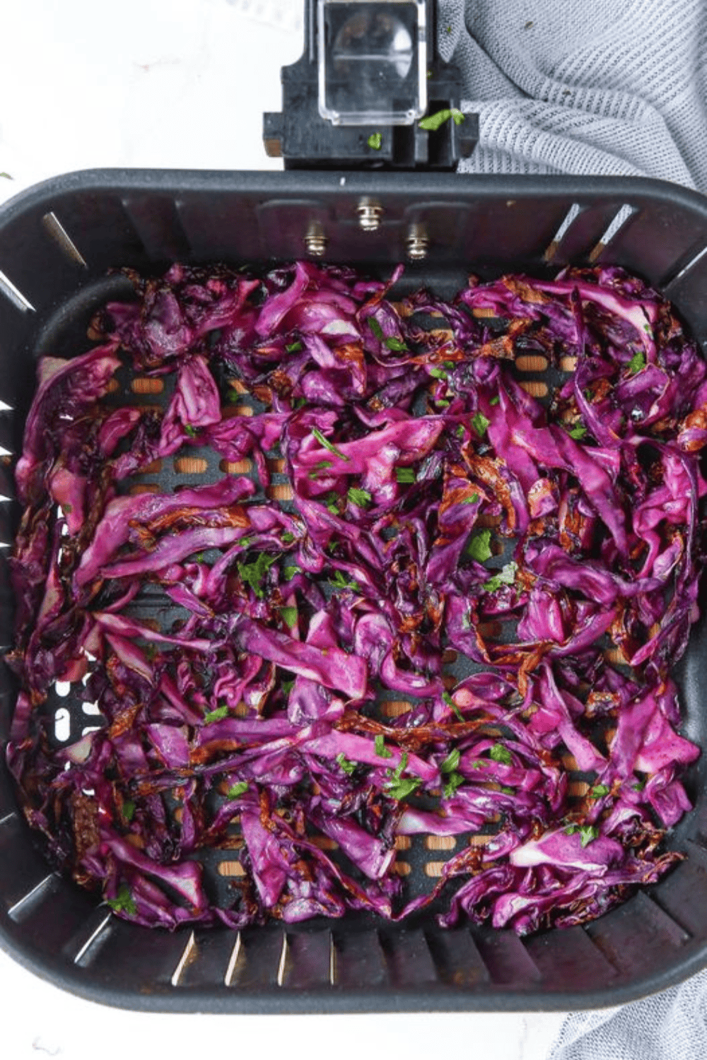 Golden, crispy red cabbage cooked in the air fryer, seasoned and ready to serve.