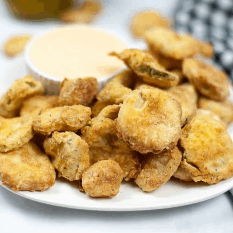 Easy air fryer Cajun fried pickles served golden and crispy with dipping sauce