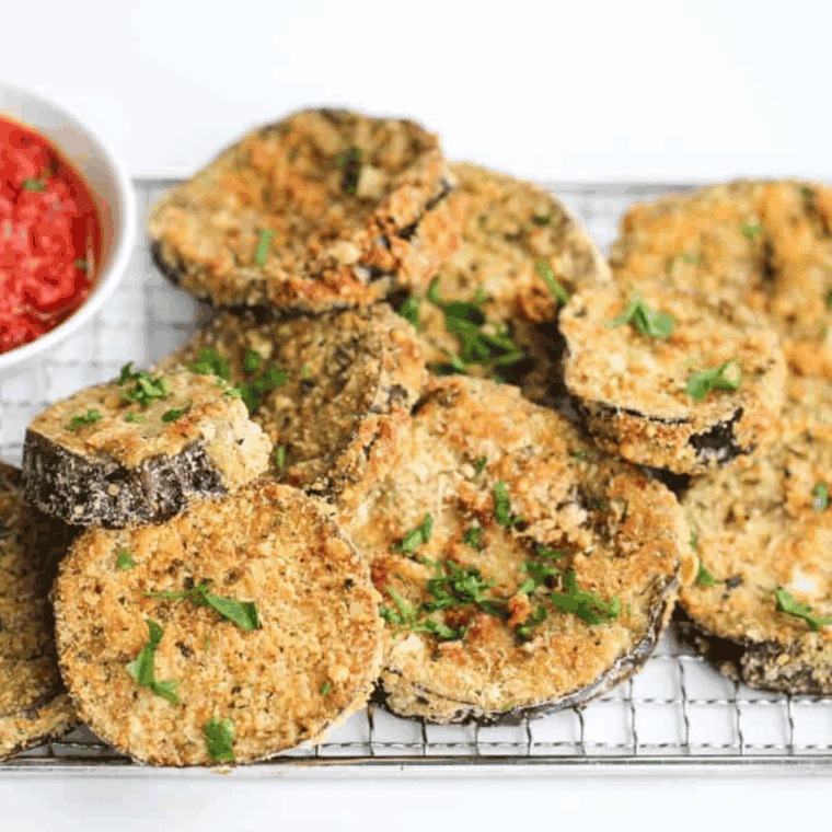 Extra-crispy gluten-free eggplant parmesan made in the air fryer with breaded eggplant slices, marinara sauce, and melted mozzarella