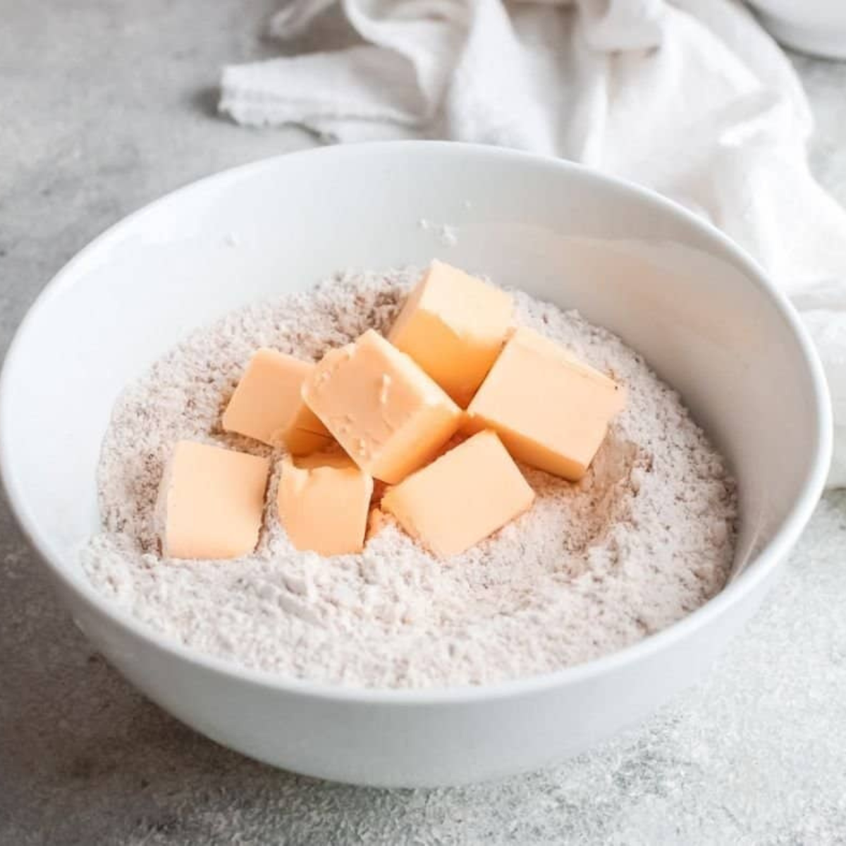 Buttermilk poured into the dry ingredients, forming a shaggy scone dough
