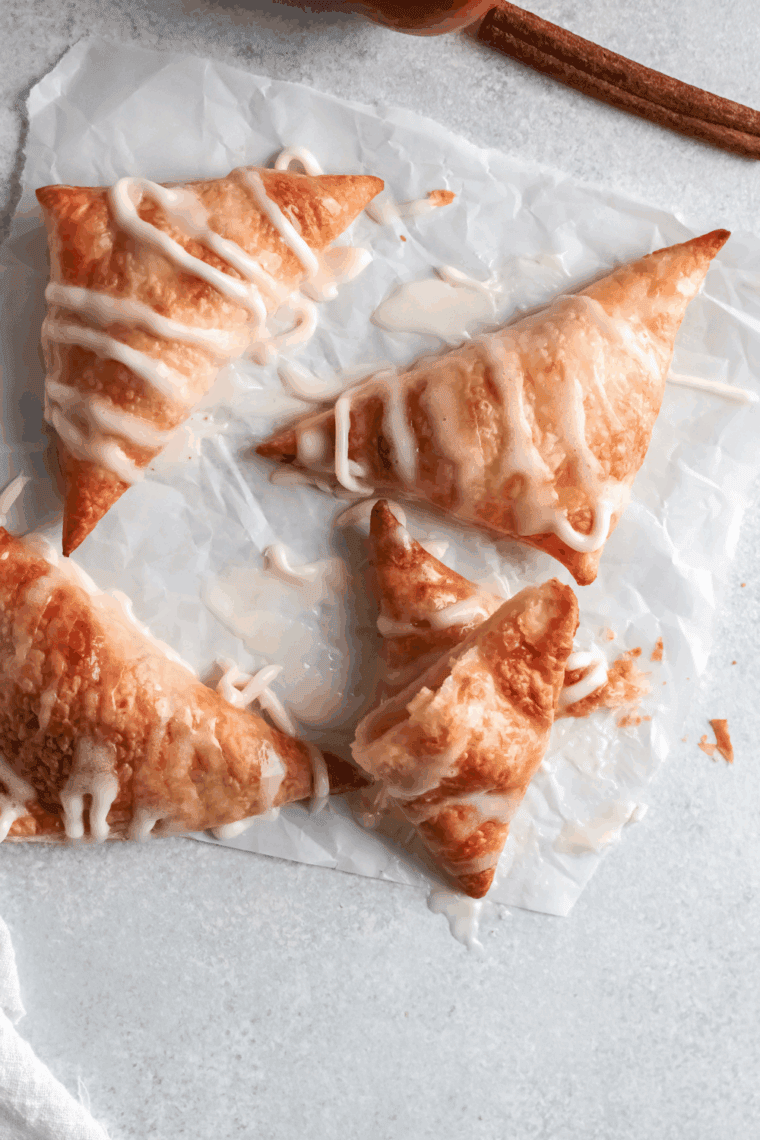 Flaky puff pastry apple turnover broken open to show the cinnamon apple filling