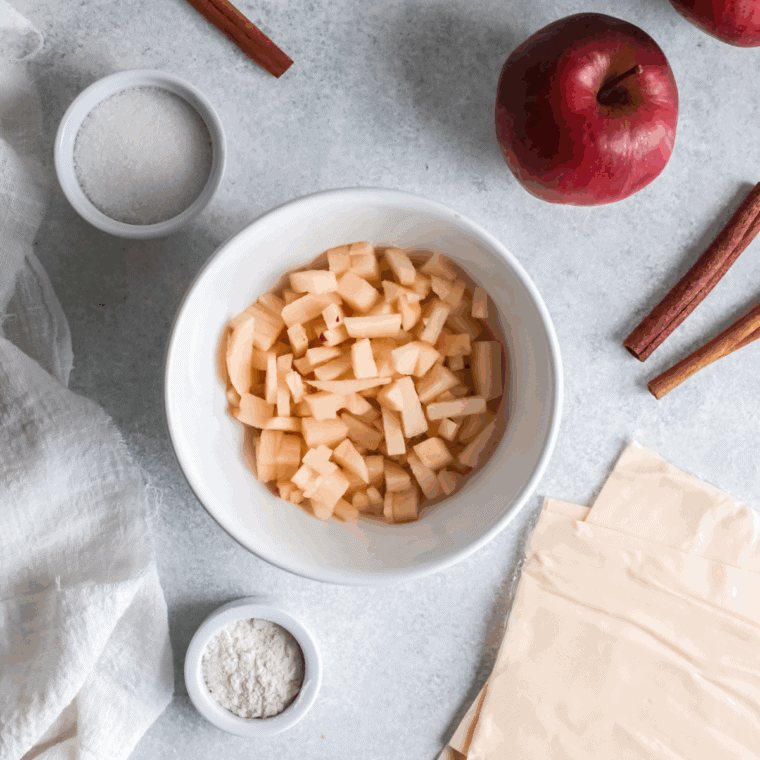 Ingredients for air fryer apple turnovers laid out on a kitchen counter.