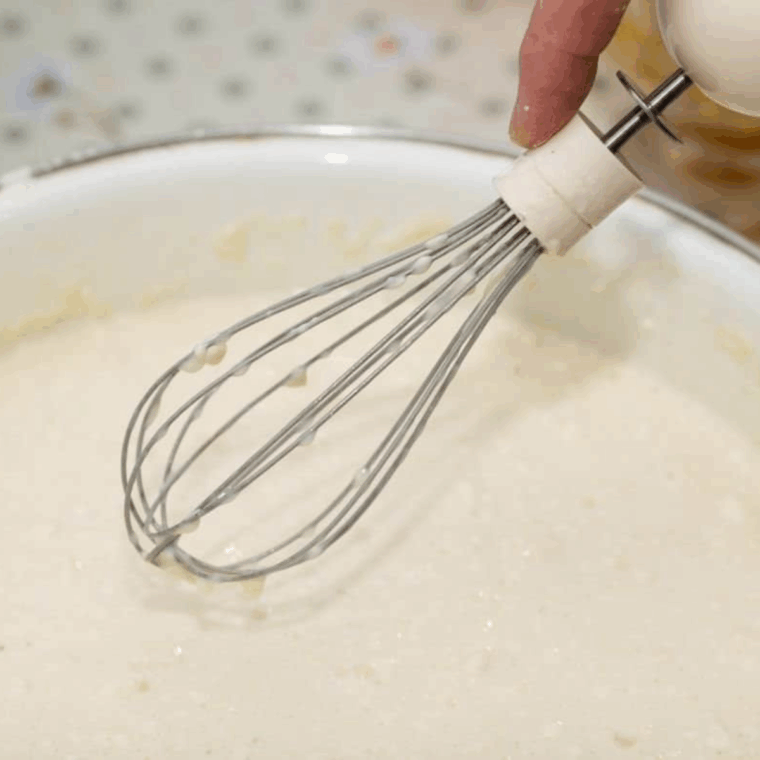 Creaming butter and sugar, then mixing in eggs, banana, sour cream, and vanilla extract.