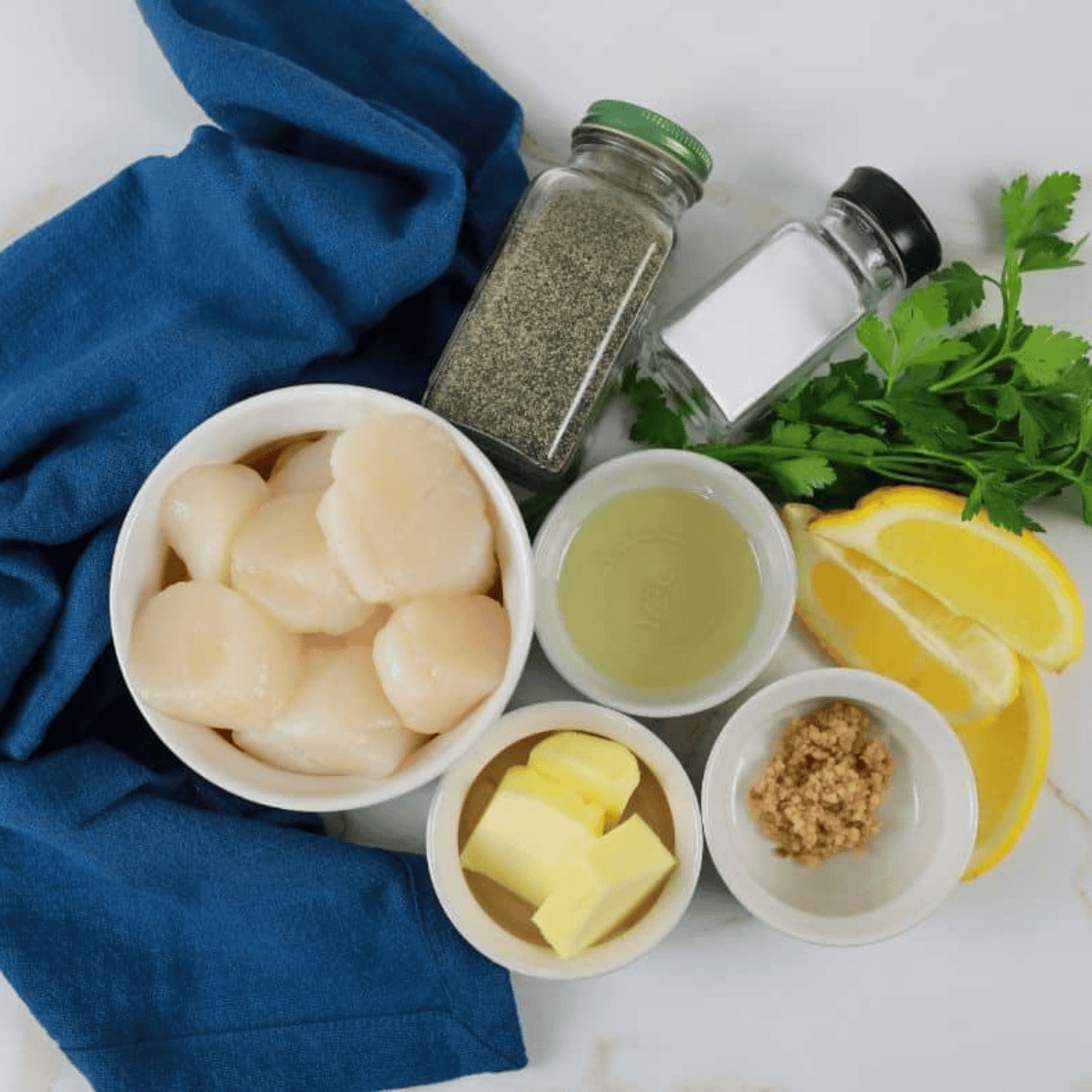Ingredients needed for Air Fryer Garlic Butter Scallops on kitchen table.