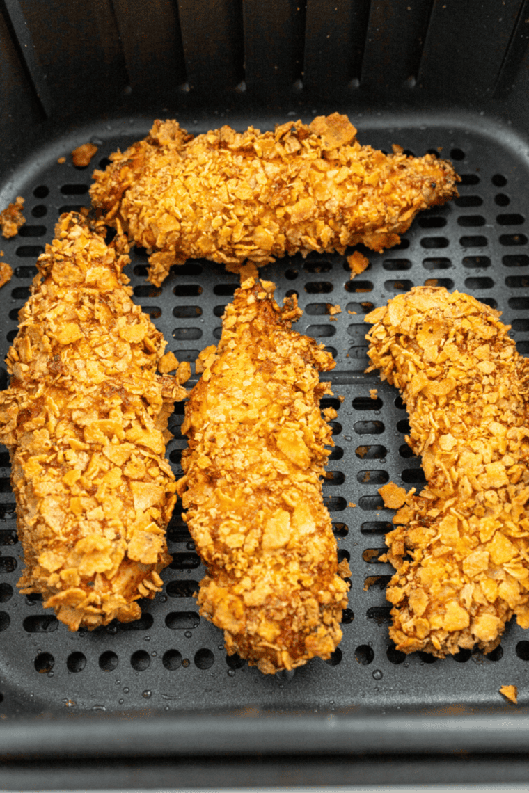 Dredging chicken tenders in flour, egg wash, and seasoned panko, then air frying until golden crispy and fully cooked.