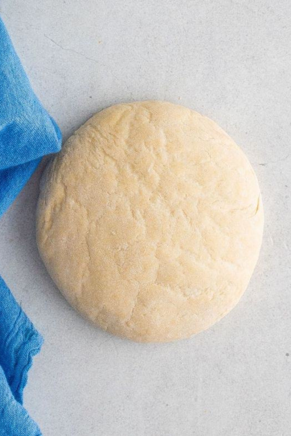 Dough being mixed in bowl for scallion pancakes with fork