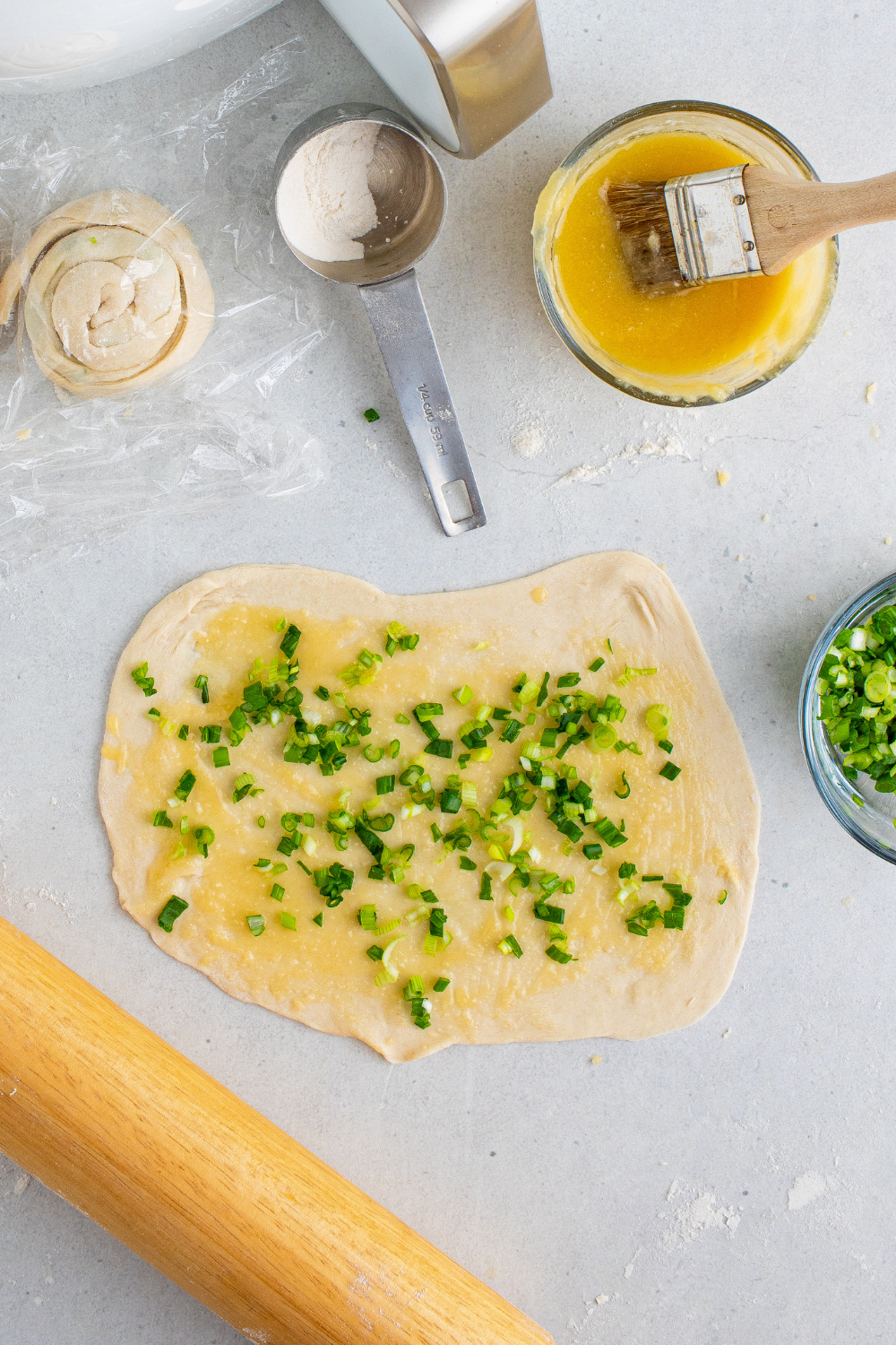 Dough ball rolled thin on floured surface for scallion pancakes