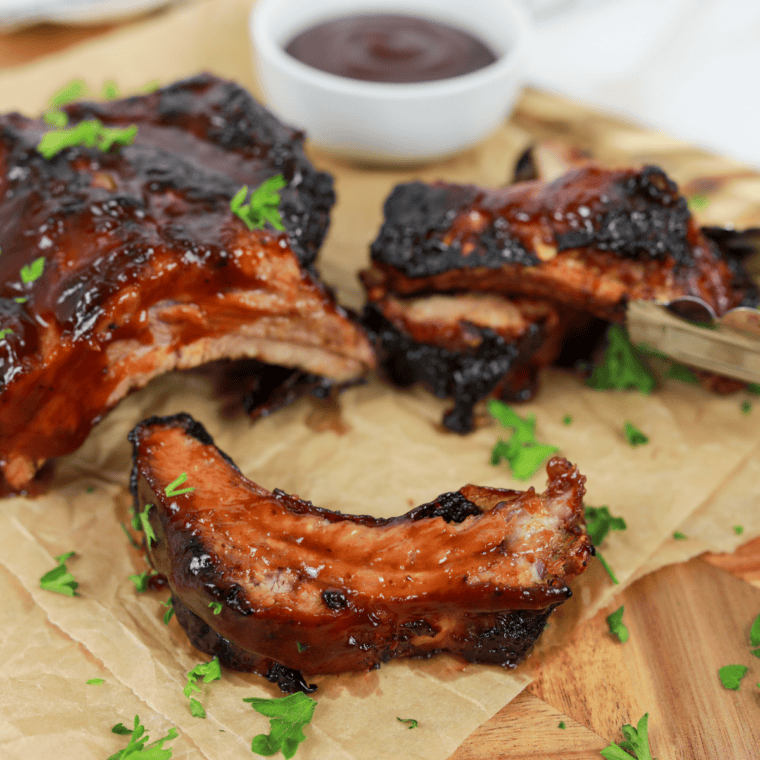 Golden-brown St. Louis style spare ribs cooked in an air fryer, served on a plate with a smoky glaze.