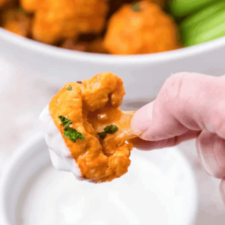 “Crispy Buffalo Wild Wings-style cauliflower bites coated in spicy Buffalo sauce, served with ranch dressing for dipping.”