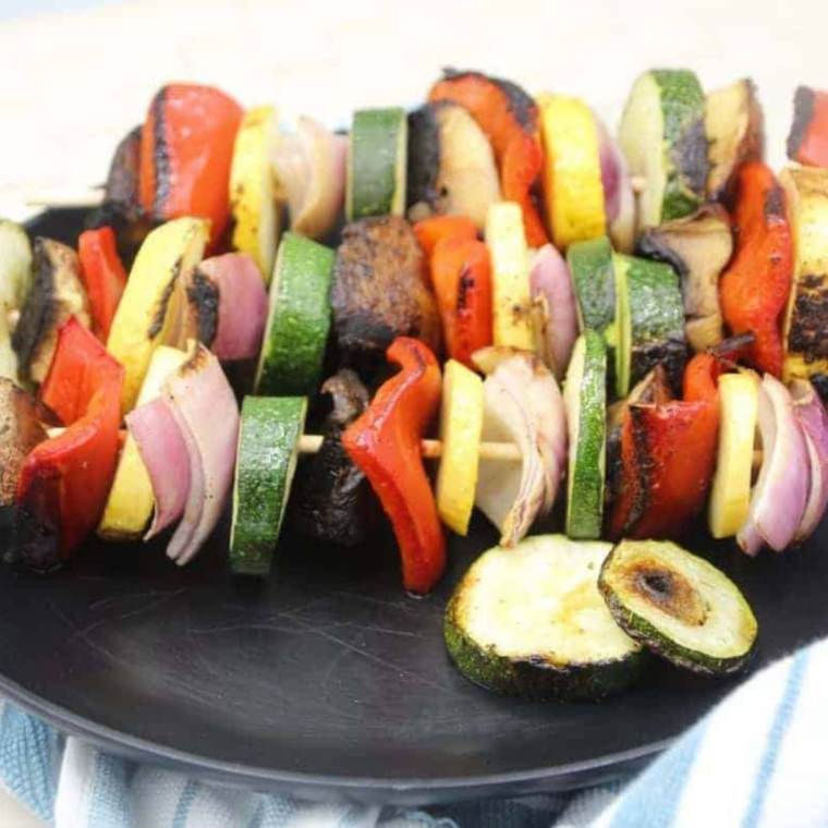 Serve: Grilled vegetable skewers plated as a colorful side dish or appetizer.