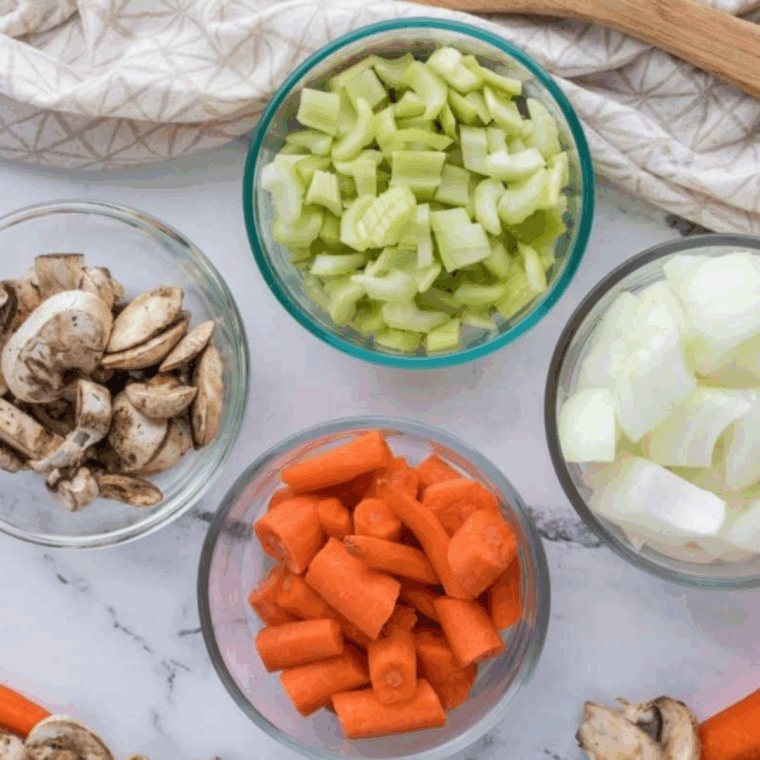Ingredients needed for Low Sodium Vegetable Stock Recipe (No Salt Added) on kitchen table.