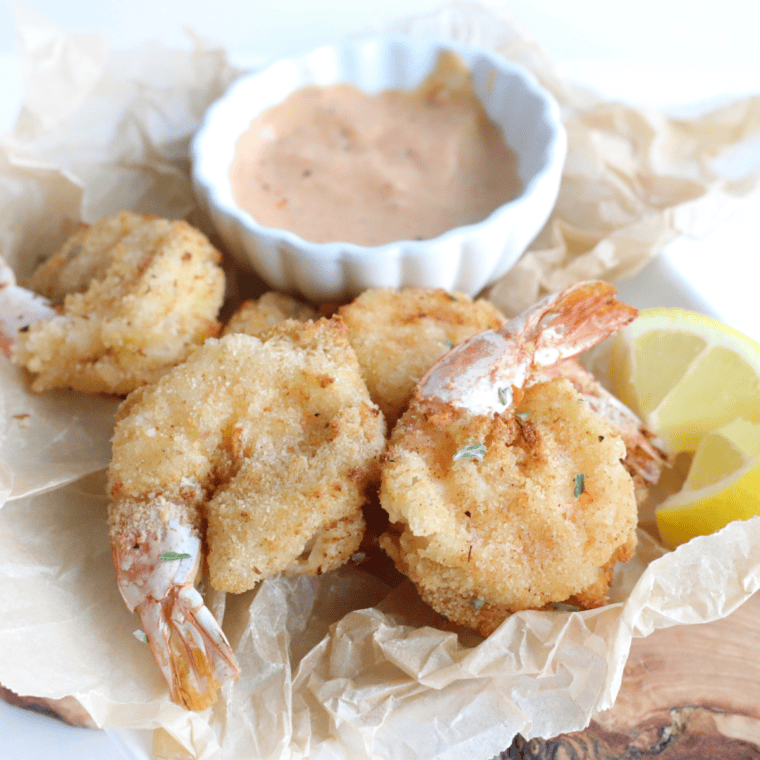 Jumbo shrimp baked in creamy Alfredo sauce with melted Parmesan cheese, served in a skillet.