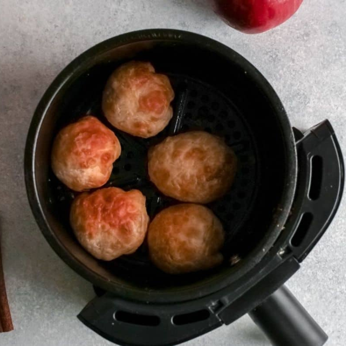 Apple pie bombs in the air fryer basket at 350°F