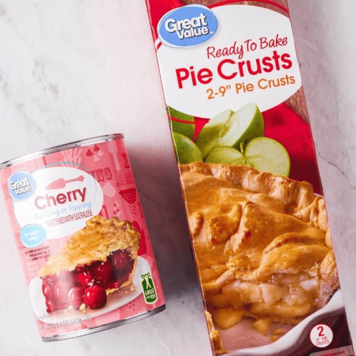 Ingredients for air fryer cherry hand pies: pie crust, cherry pie filling, egg, and sugar