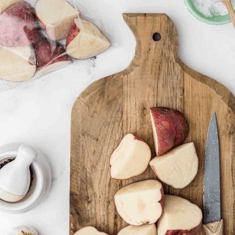 Preheat air fryer to 400°F and chop red potatoes into evenly sized chunks for cooking.