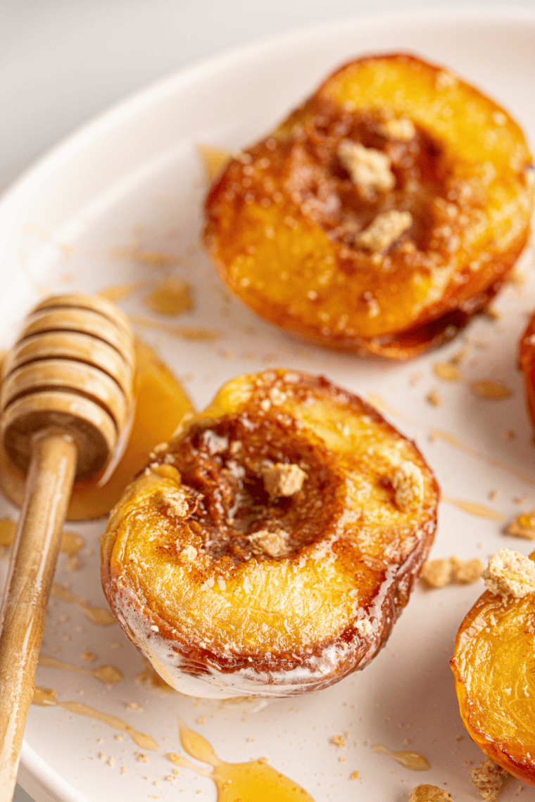 Caramelized air fryer peaches topped with brown sugar and cinnamon, soft and juicy.
