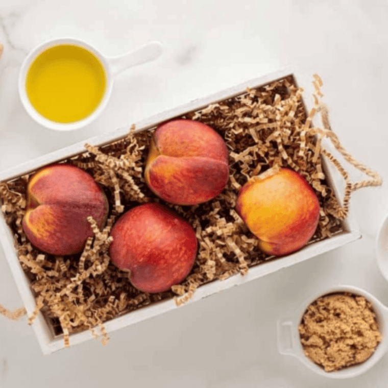 Ingredients needed for Easy Air Fryer Peaches With Brown Sugar and Cinnamon on kitchen table.