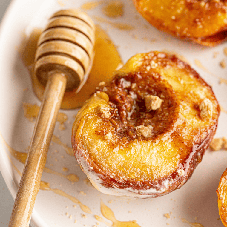 Air fryer peaches topped with brown sugar and cinnamon, soft and caramelized.
