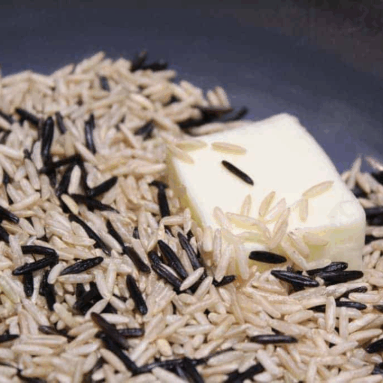Rinsing wild rice under cold water in fine mesh strainer