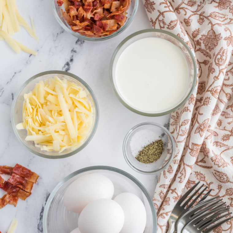 Ingredients for air fryer egg muffins: eggs, milk, shredded cheddar, salt, and pepper