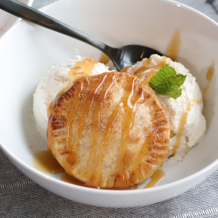 Air Fryer Caramel Apple Hand Pies served warm over a scoop of vanilla ice cream