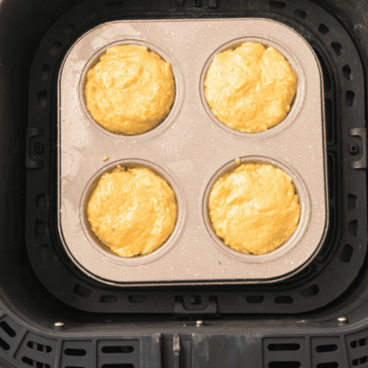 Golden air fryer jalapeño corn muffins cooling slightly in muffin tin after cooking