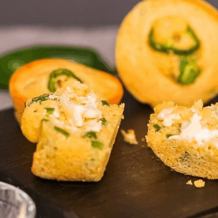 Golden air fryer jalapeño corn muffins with visible pepper pieces
