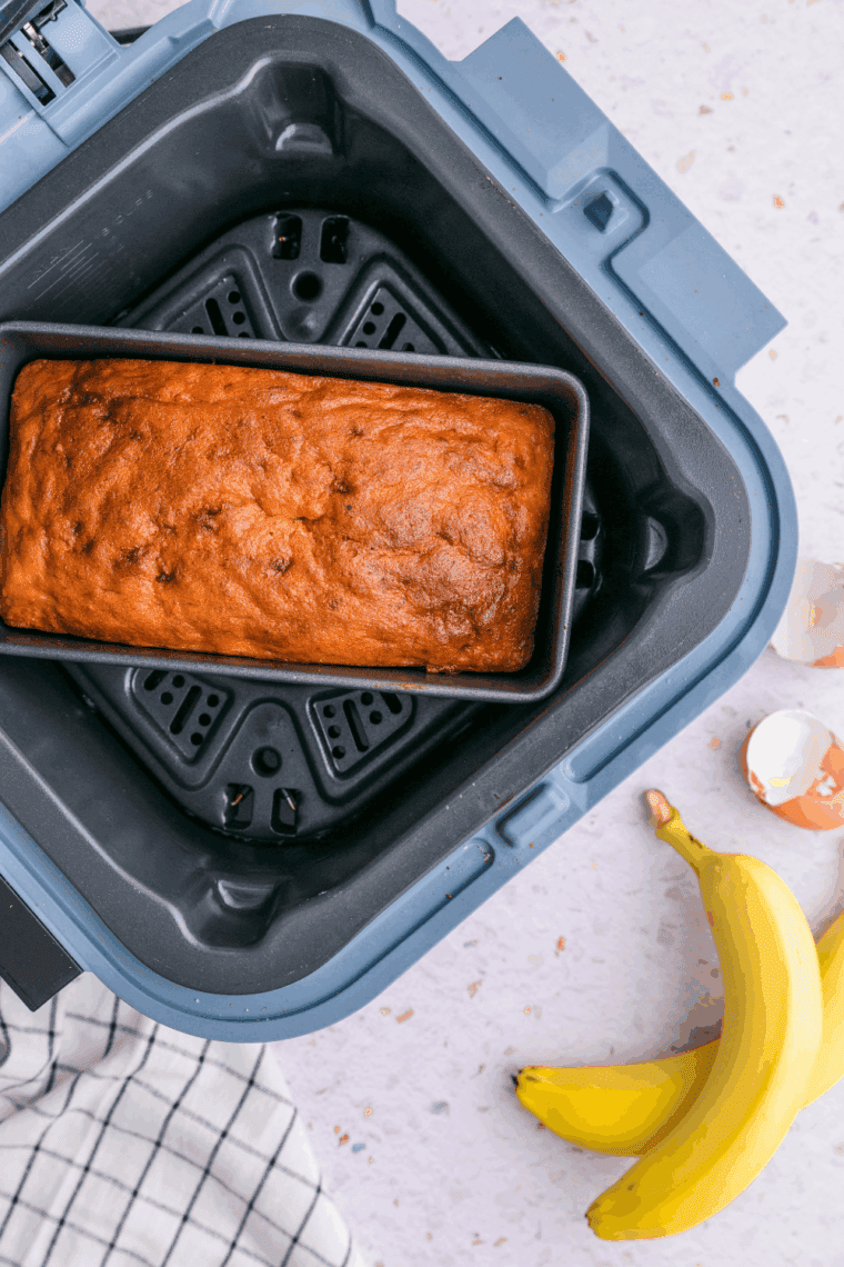 Cooked banana cake in the air fryer basket.