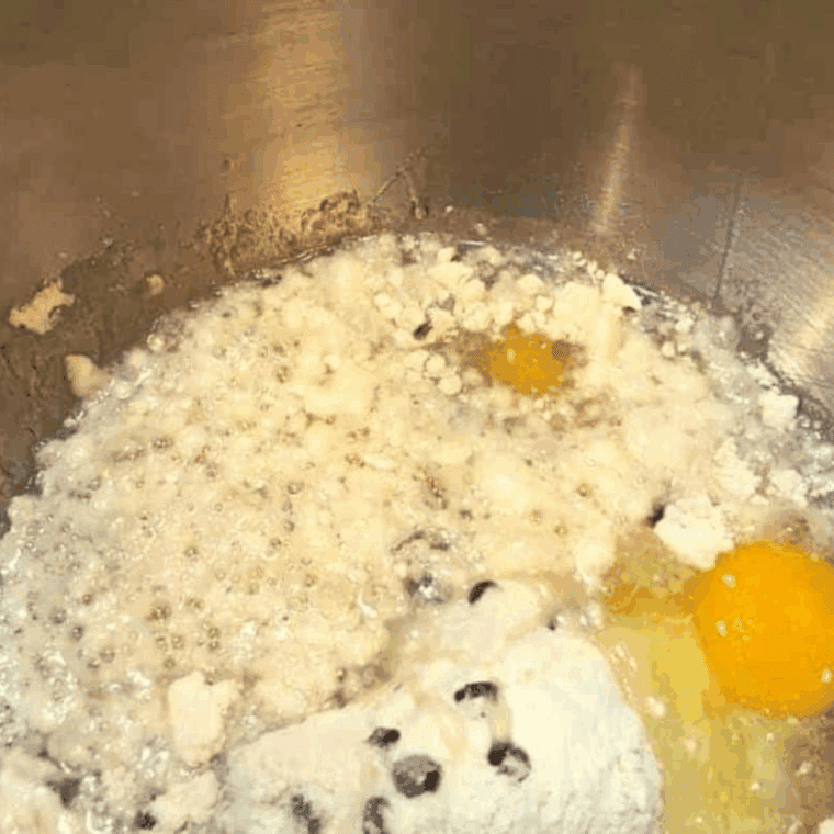 Mixing egg, water, and oil into Betty Crocker chocolate chip muffin mix according to package instructions