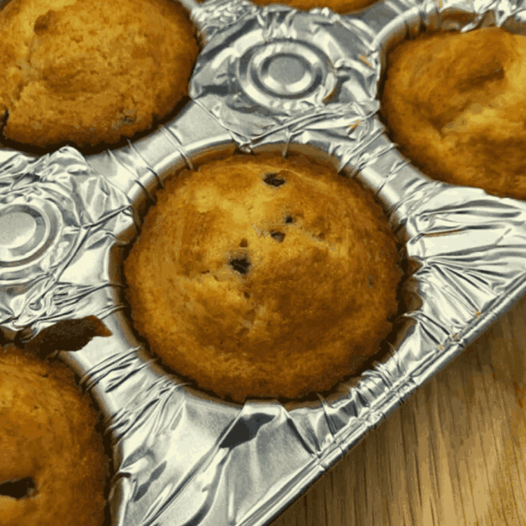Golden air fryer chocolate chip muffins made from Betty Crocker mix, with melty chocolate chips and fluffy centers, freshly baked and ready to enjoy.