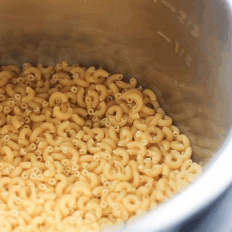 Place the uncooked pasta into the Instant Pot bowl.
