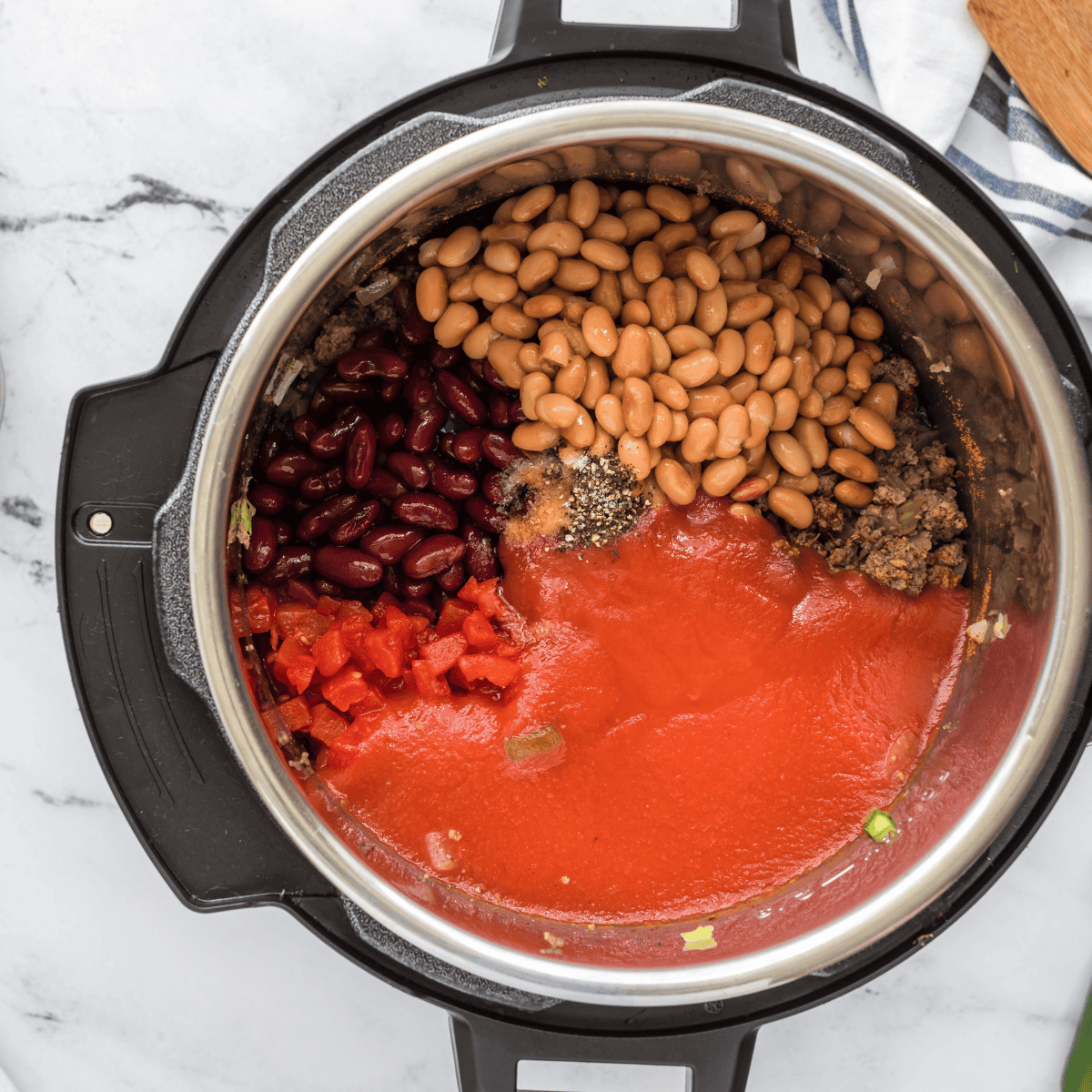 Cinnamon, cocoa, chili powder, and spices stirred into the beef mixture for Skyline-style chili
