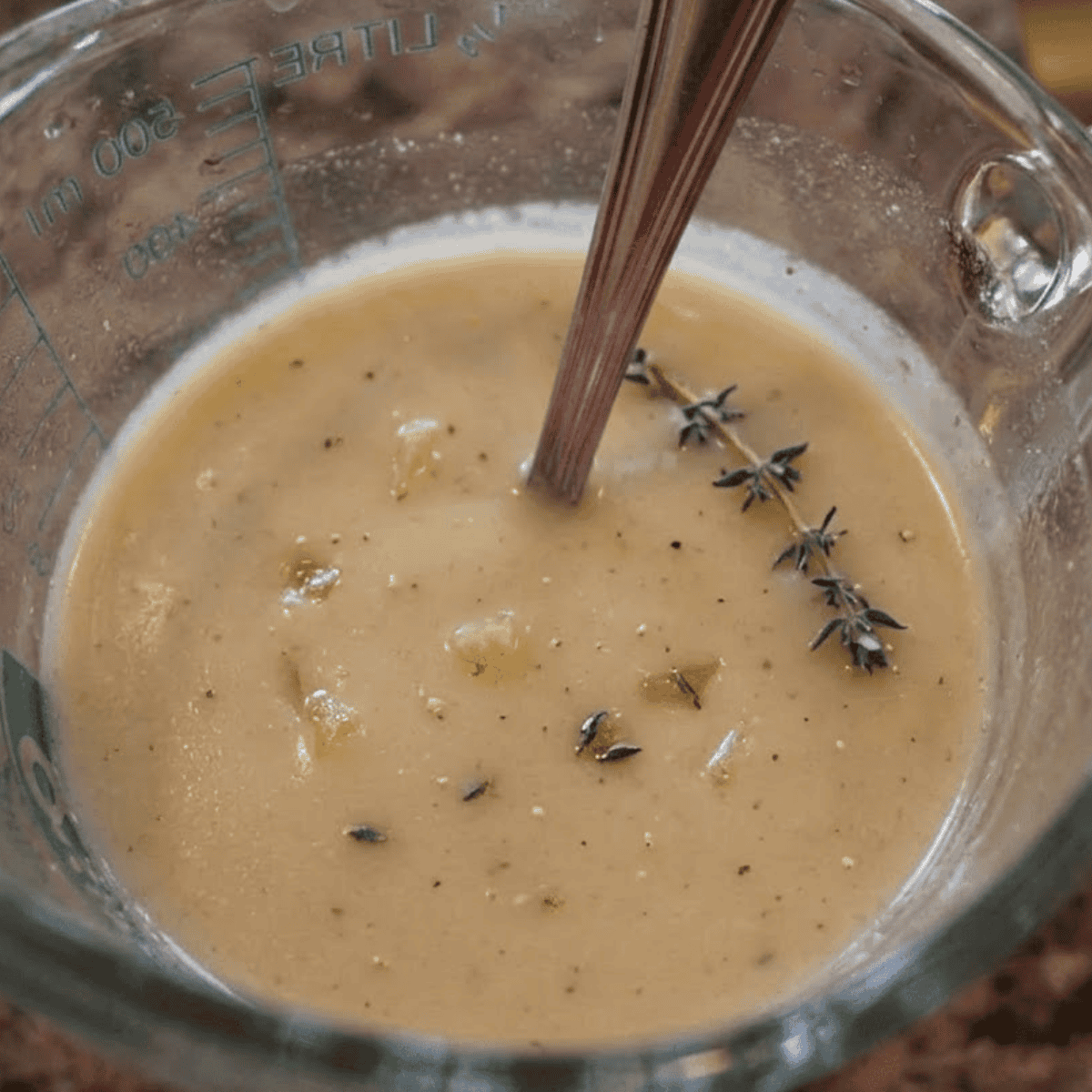 Pouring ranch seasoning mixture over chicken and cream cheese in the Instant Pot