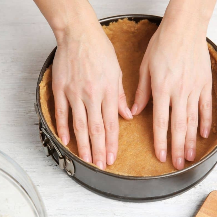 Graham cracker crumbs pressed one inch up the sides of a springform pan using the bottom of a measuring cup
