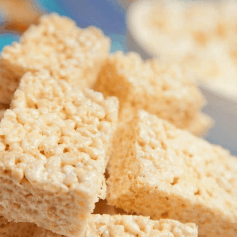 Plate of golden, gooey Instant Pot Rice Krispie Treats stacked on top of each other
