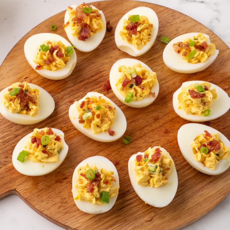 Plated Instant Pot Southern deviled eggs topped with paprika and sweet gherkin slices