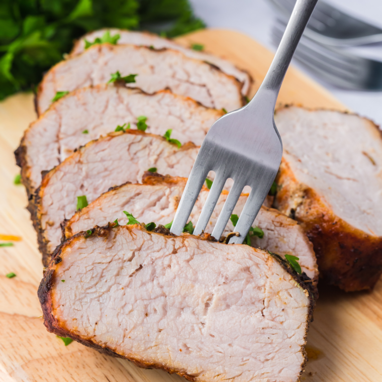 Sliced marinated pork tenderloin cooked in air fryer on serving platter