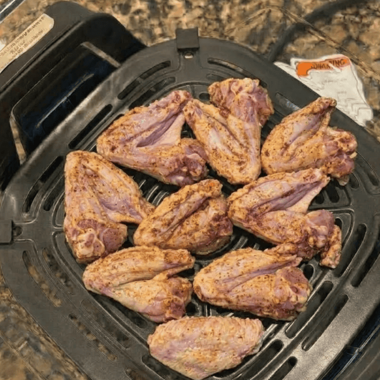 Golden crispy chicken wings finishing on Max Crisp in the Ninja Crispi