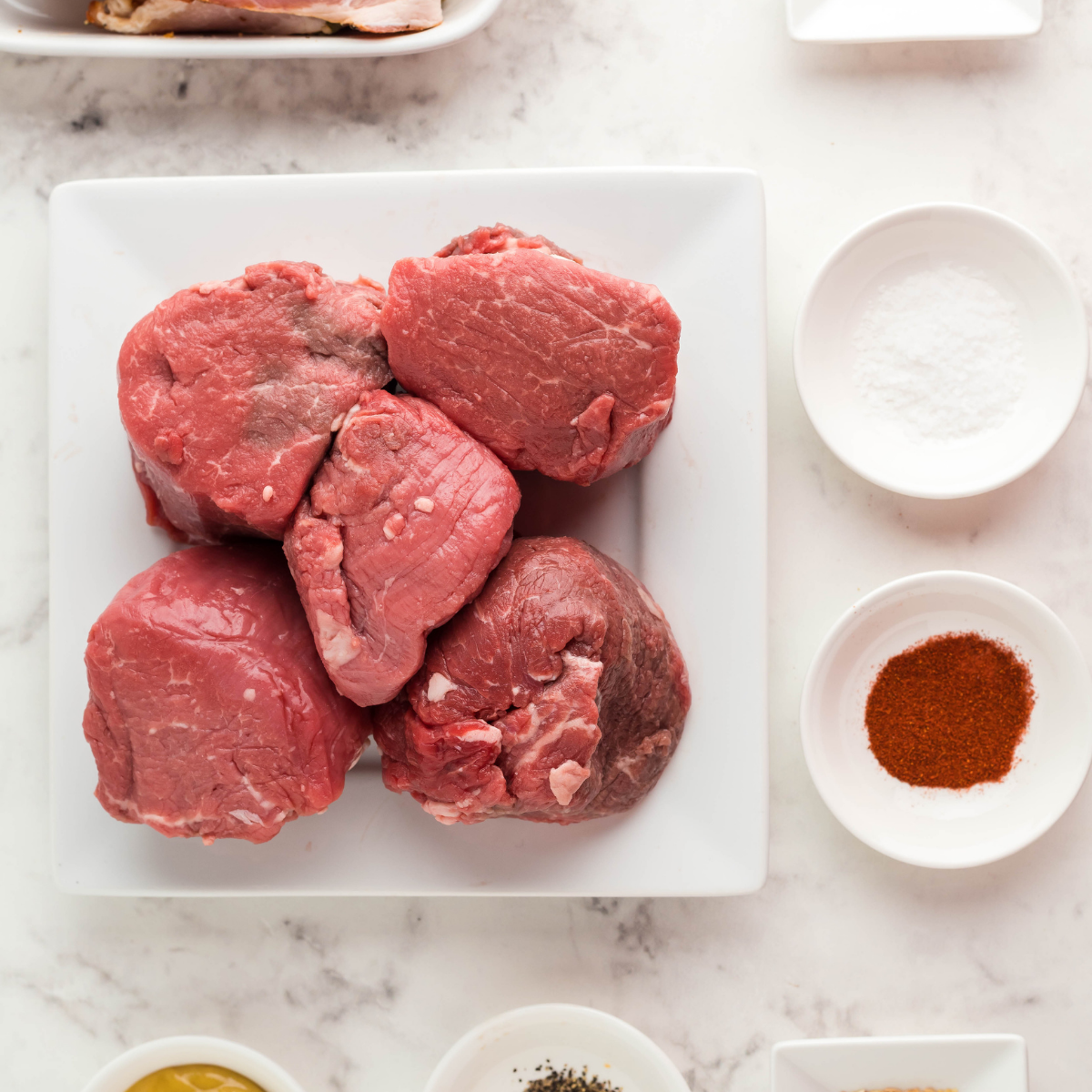 Ingredients needed for Air Fryer Beef Tenderloin (Filet Mignon) on kitchen table.