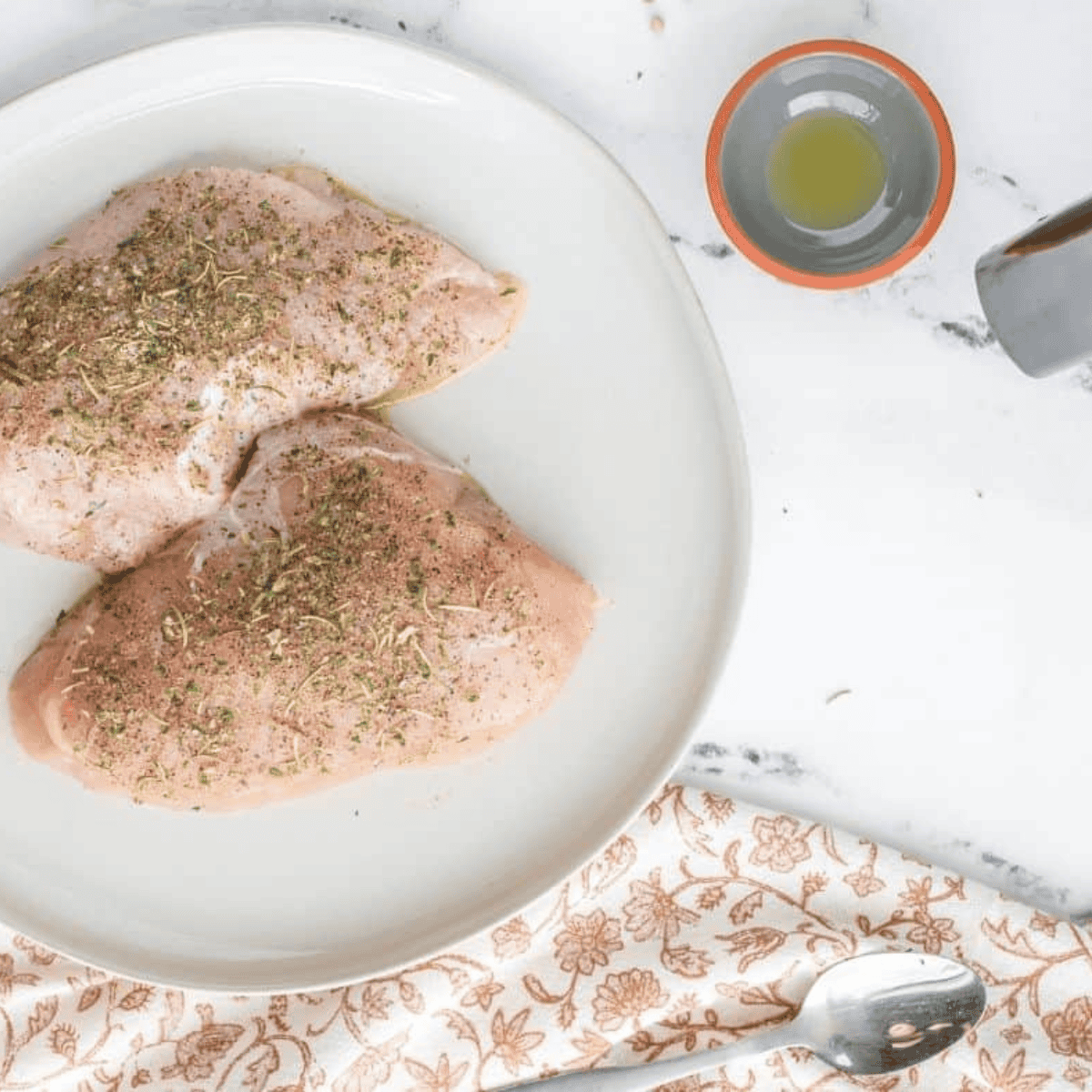 Coating turkey tenderloin evenly with marinade before air frying for flavorful results.