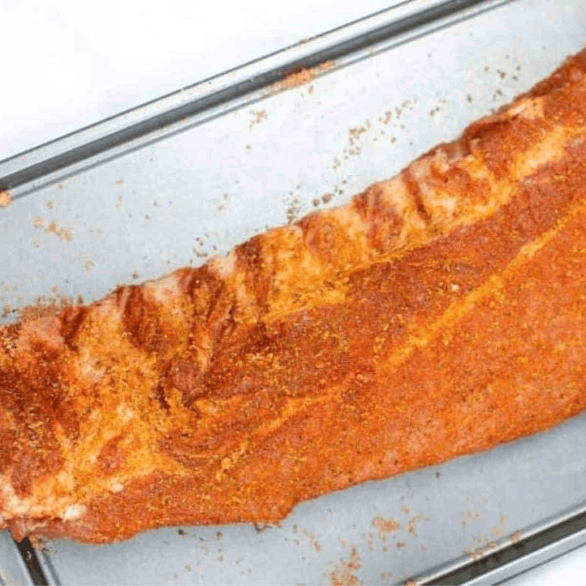 Rub the dry rub over the ribs.