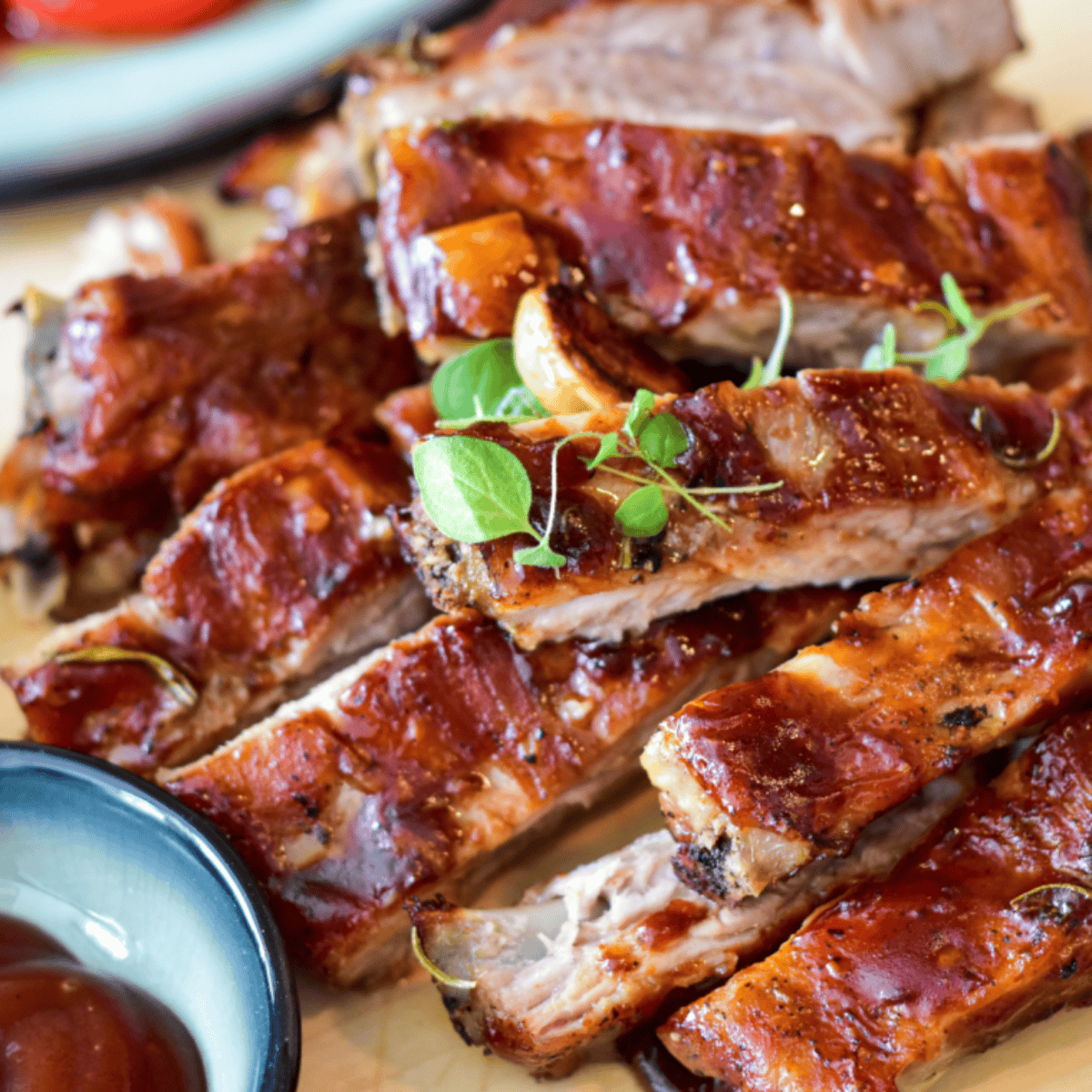 Delicious Tony Roma's Baby Back Ribs copycat, coated in sweet and tangy BBQ sauce, served with coleslaw and fries.