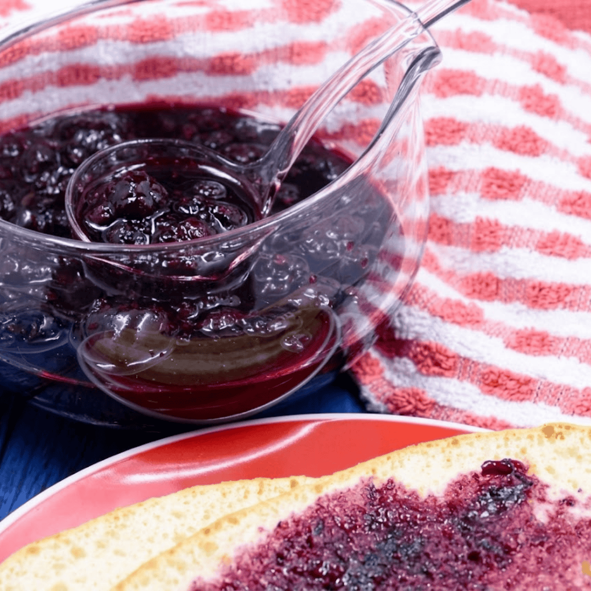 Finished Instant Pot mixed berry jam cooling in a glass mason jar