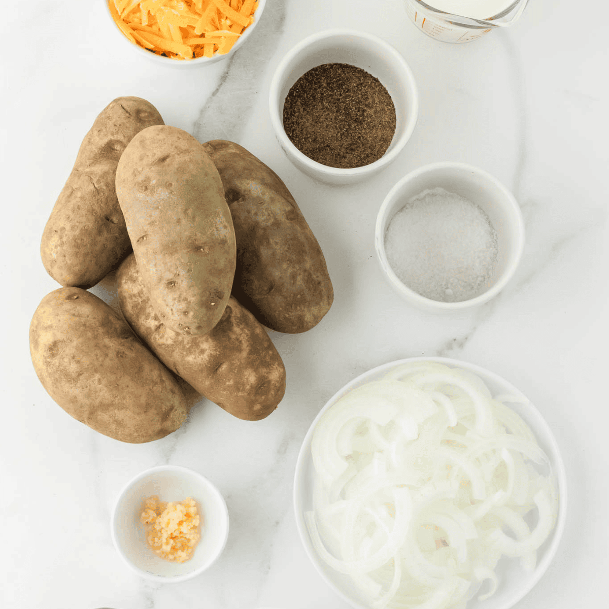 Ingredients needed for Omaha Steaks Scalloped Potatoes Recipe on kitchen table.