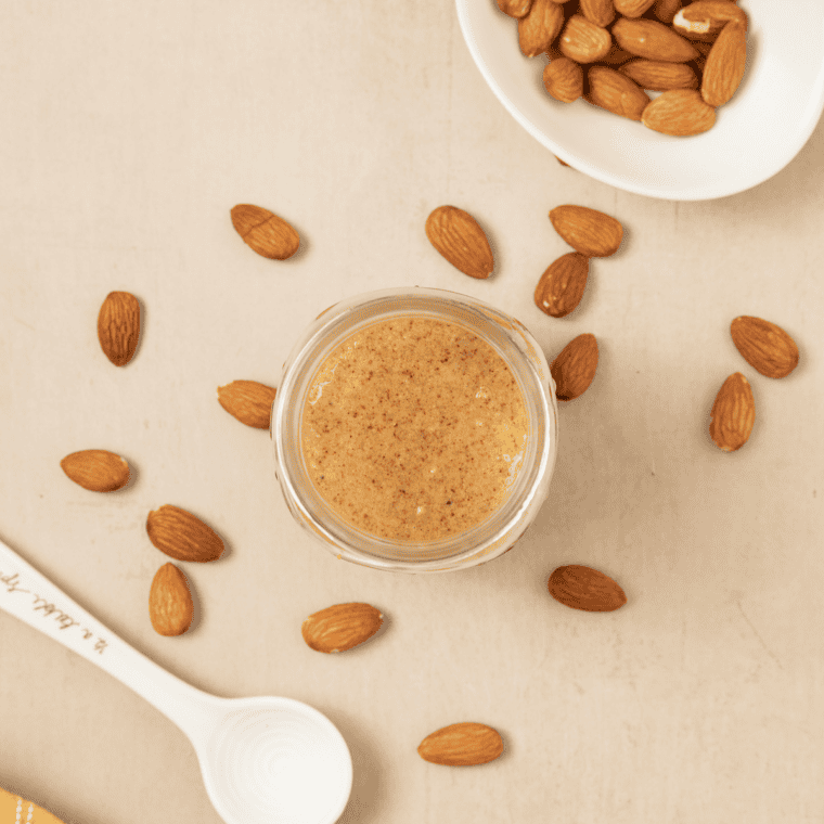 Air fryer roasted almonds in a white bowl, golden and crunchy