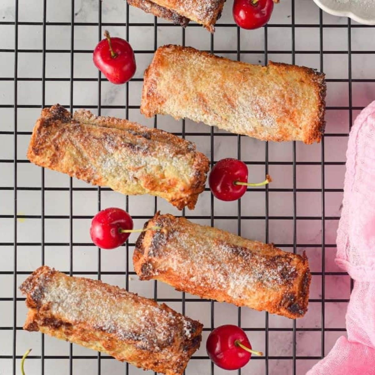Air fryer French toast stuffed with Nutella and cherries, golden brown and crispy on a plate