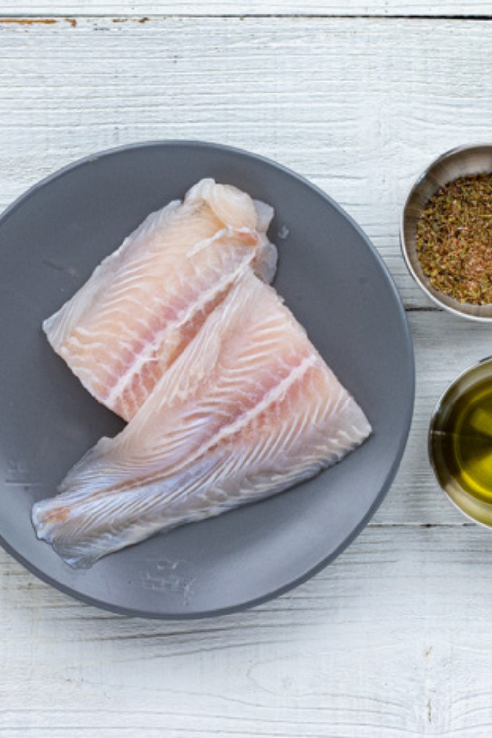 Ingredients needed for Air Fryer Chilean Sea Bass With Lemon Garlic Butter on kitchen table.