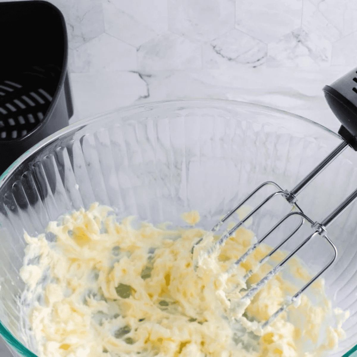 Mixing creamy peanut butter, brown sugar, granulated sugar, eggs, and vanilla extract in a large bowl until smooth.
